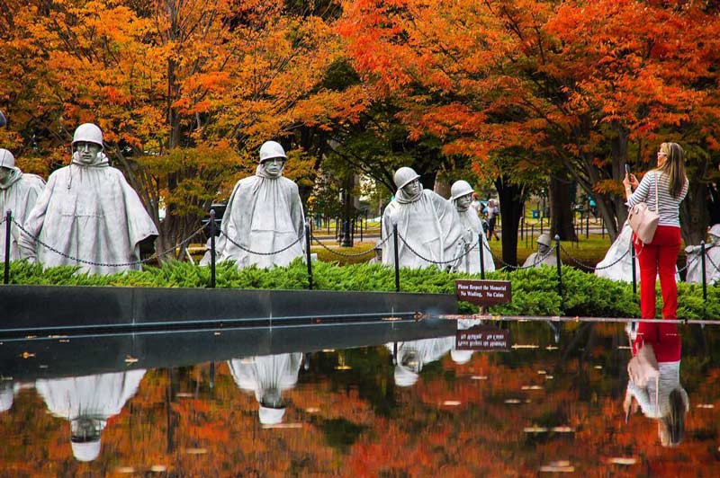 @sinhat25 - Woman taking photo of Korean War Veterans Memorial - Fall foliage in Washington, DC