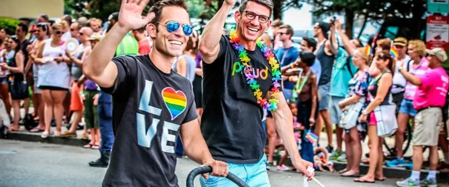 Couple walking with child during Capital Pride Parade - LGBTQ Summer Events in Washington, DC