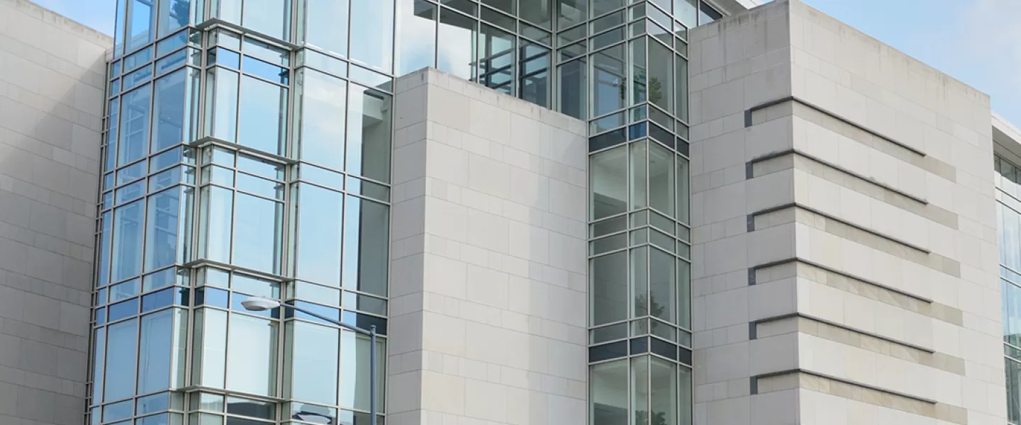 building with people crossing the street in front of it