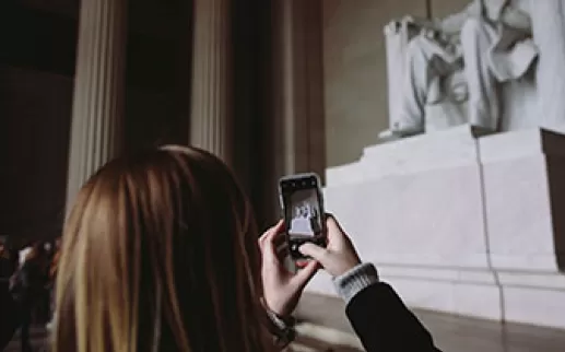 Girl taking photo of Lincoln Memorial