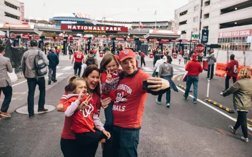 Family taking selfie in front of Nationals Park before Washington Nationals baseball game in Washington, DC