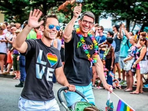 Couple walking with child during Capital Pride Parade - LGBTQ Summer Events in Washington, DC