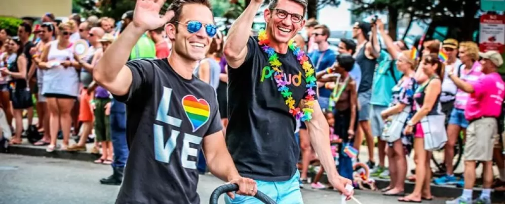 Couple walking with child during Capital Pride Parade - LGBTQ Summer Events in Washington, DC